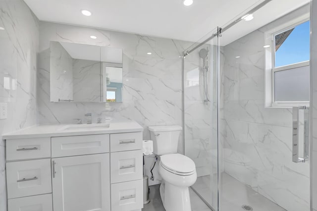 bathroom with vanity, toilet, an enclosed shower, and tile walls