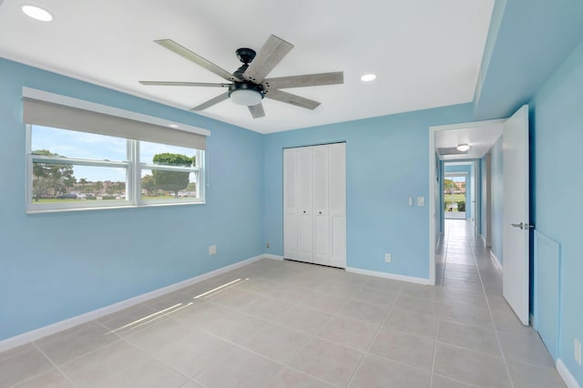 unfurnished bedroom featuring a closet, ceiling fan, and light tile patterned flooring