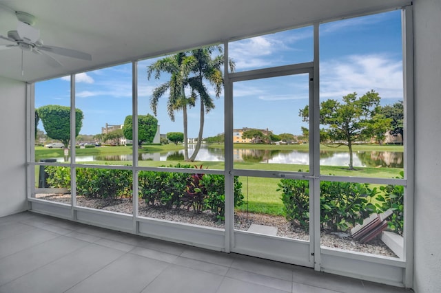 unfurnished sunroom with a water view, ceiling fan, and a healthy amount of sunlight