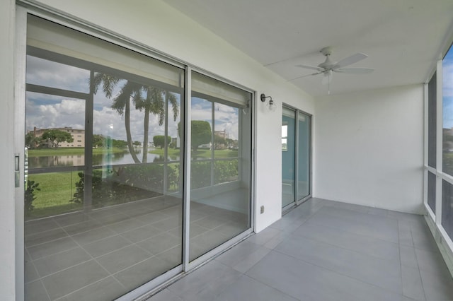 exterior space with a water view, a patio, and ceiling fan