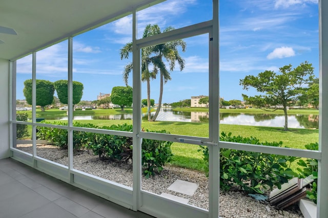 unfurnished sunroom with a water view