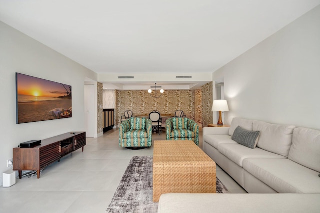 living room featuring a notable chandelier and tile patterned flooring