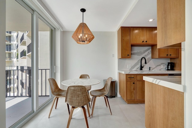 kitchen with hanging light fixtures, sink, and a chandelier