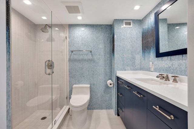 bathroom featuring a shower with shower door, vanity, and toilet