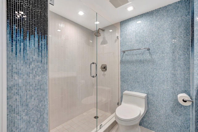 bathroom featuring walk in shower and toilet