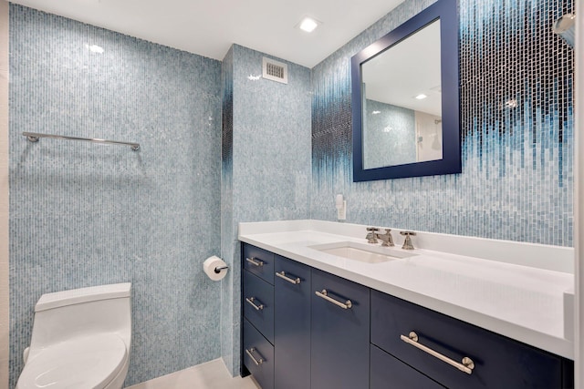 bathroom featuring vanity and toilet