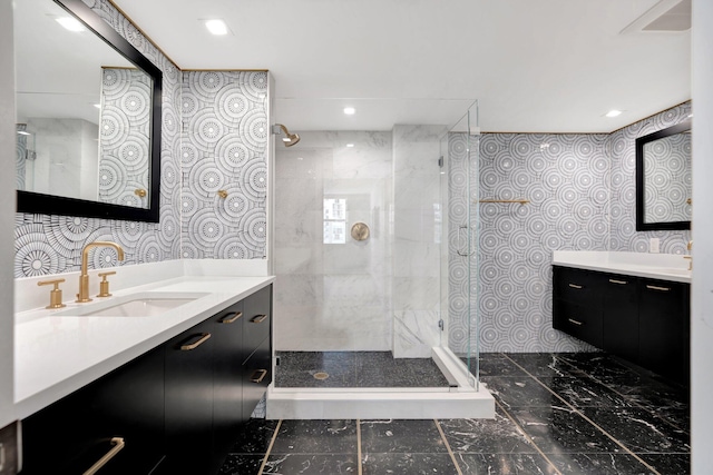 bathroom with tiled shower and vanity