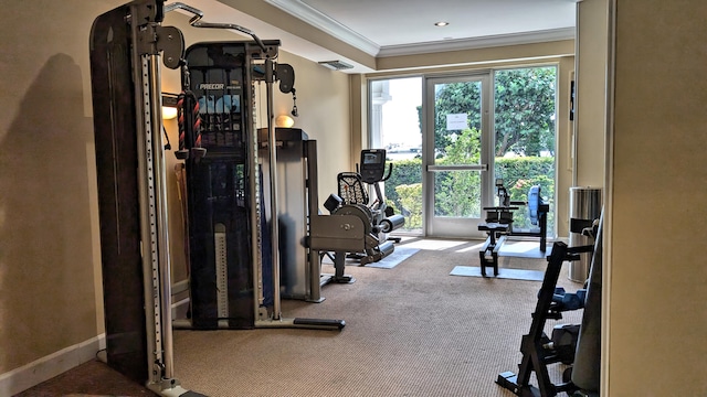 workout room featuring carpet flooring, ornamental molding, and a wealth of natural light