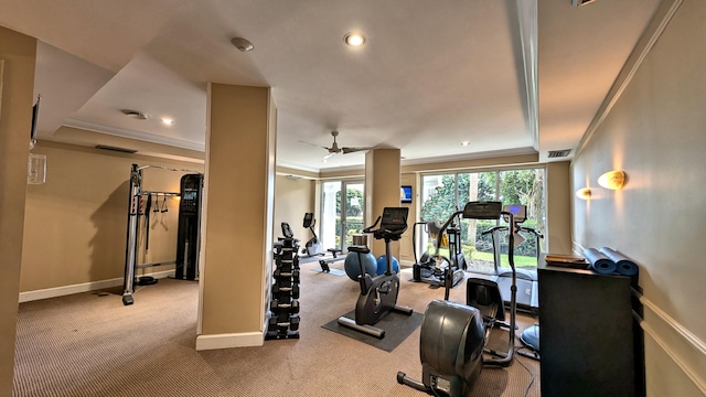 interior space featuring ceiling fan, light colored carpet, a raised ceiling, and ornamental molding