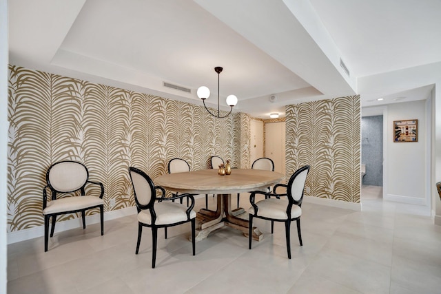 dining room featuring a tray ceiling and an inviting chandelier