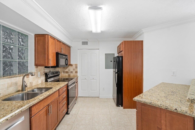 kitchen with light stone countertops, sink, tasteful backsplash, and black appliances