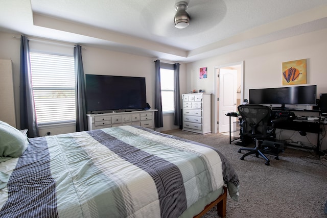 bedroom with a textured ceiling, carpet, and ceiling fan