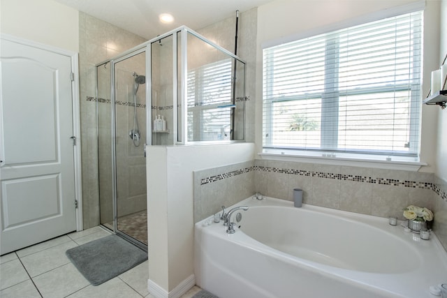 bathroom with a wealth of natural light, tile patterned flooring, and plus walk in shower