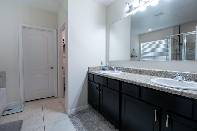 bathroom with tile patterned floors, independent shower and bath, a textured ceiling, and vanity