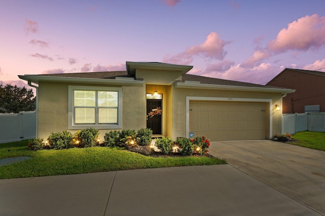 prairie-style home featuring a yard and a garage