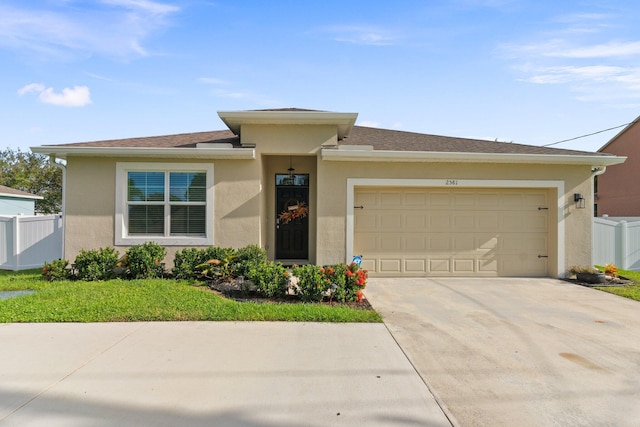 2581 SW Savage Blvd, Port Saint Lucie, FL 34953 - view of front of property with stucco siding, fence, driveway, and a garage