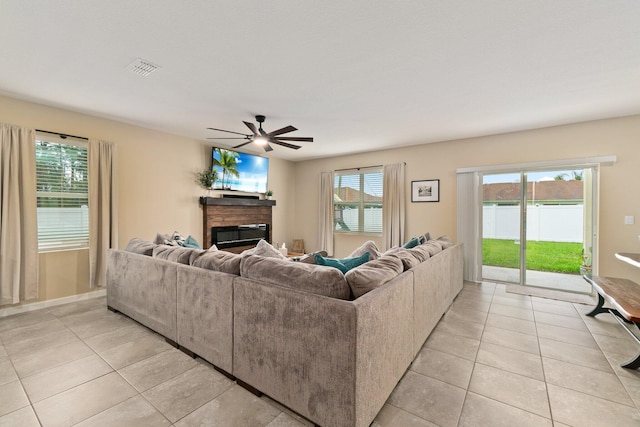 living room with ceiling fan, light tile patterned floors, and a wealth of natural light