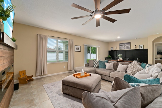 living room with ceiling fan and light tile patterned flooring