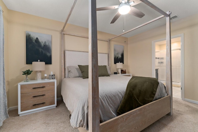 carpeted bedroom with ceiling fan and ensuite bathroom