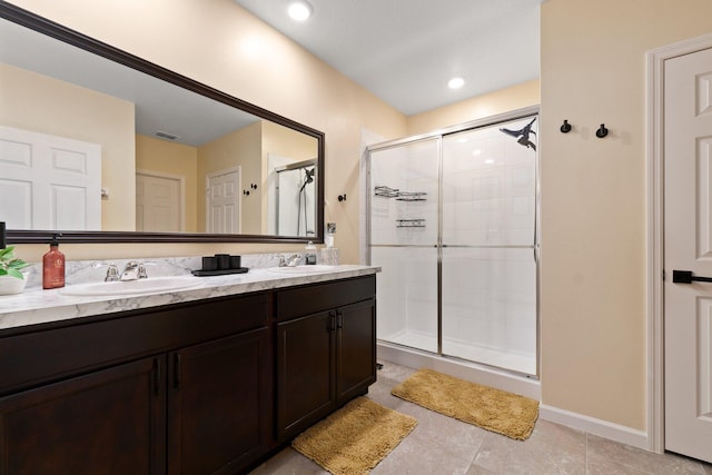 bathroom with tile patterned floors, vanity, and a shower with shower door