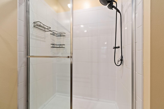 bathroom with a shower with door