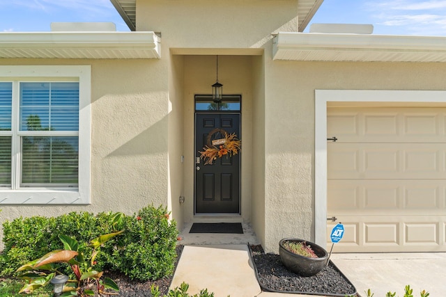 view of exterior entry with a garage