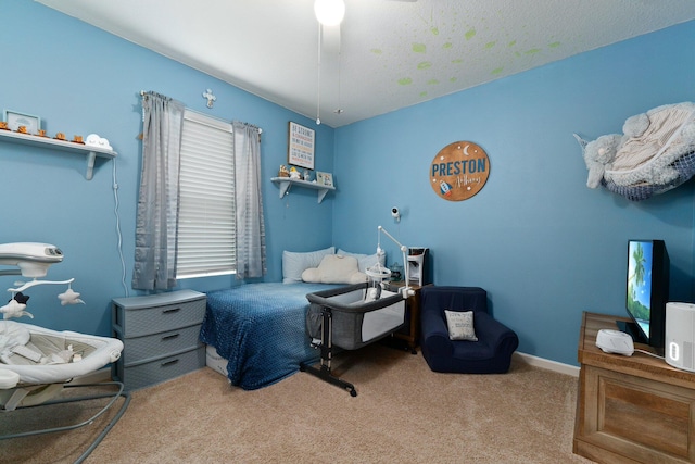 bedroom featuring ceiling fan and light carpet