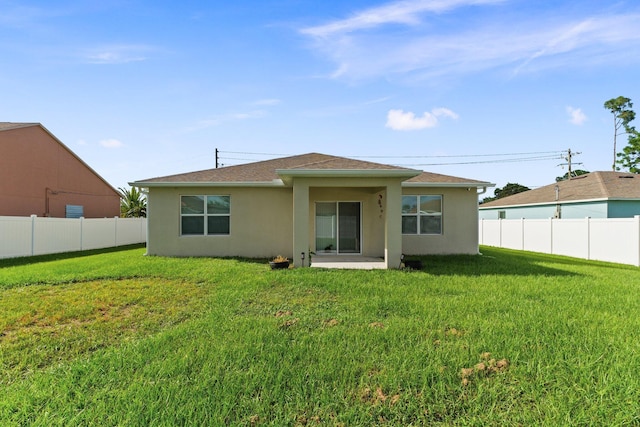 back of house with a yard