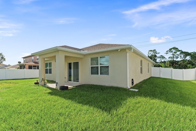 back of property featuring a lawn