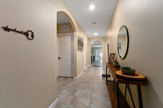 corridor with light tile patterned flooring