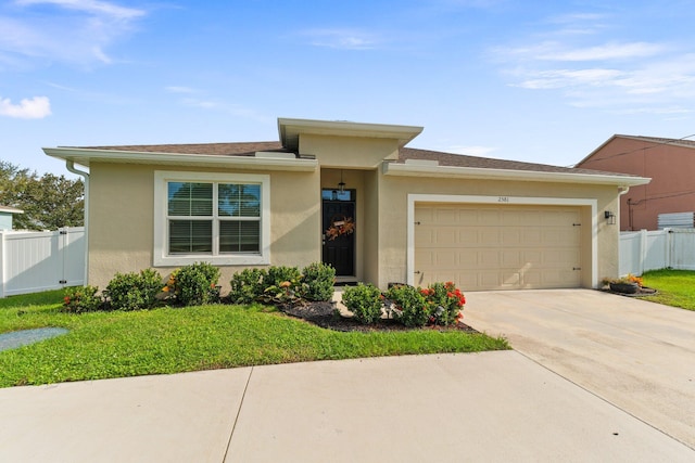 view of front facade with a garage and a front lawn