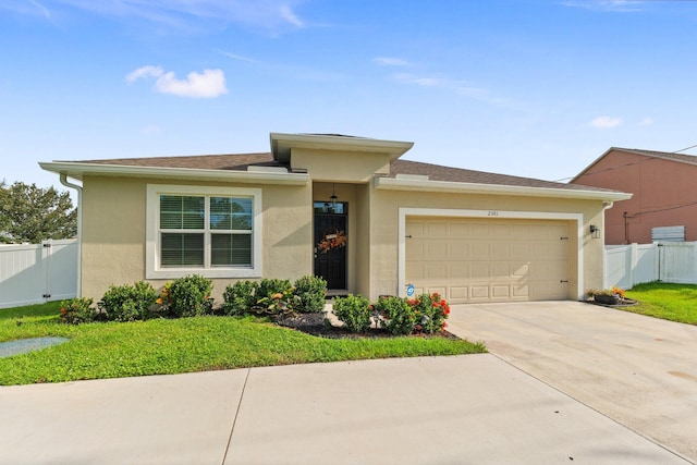 view of front of home with a garage and a front yard