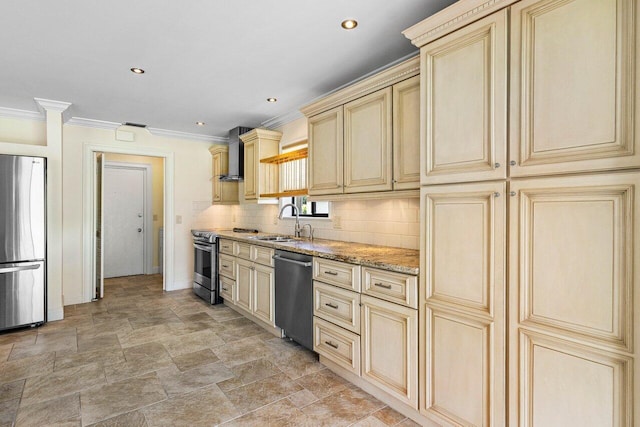 kitchen featuring sink, cream cabinetry, wall chimney range hood, stainless steel appliances, and light stone countertops