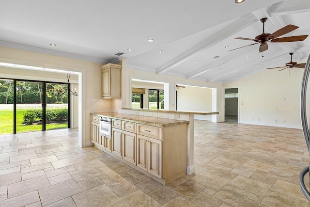 kitchen featuring ceiling fan, light brown cabinets, lofted ceiling with beams, and kitchen peninsula