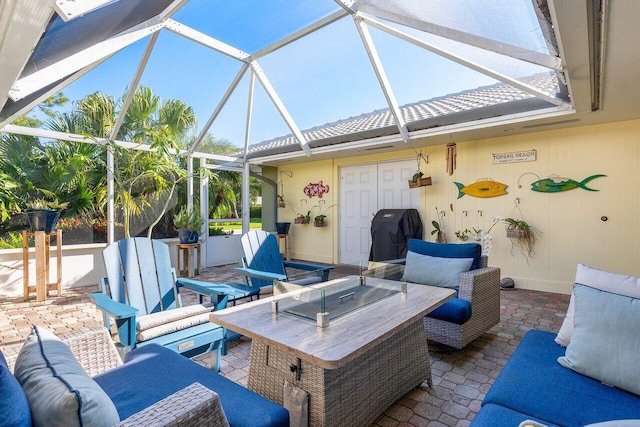 view of patio / terrace with a lanai, an outdoor hangout area, and a grill