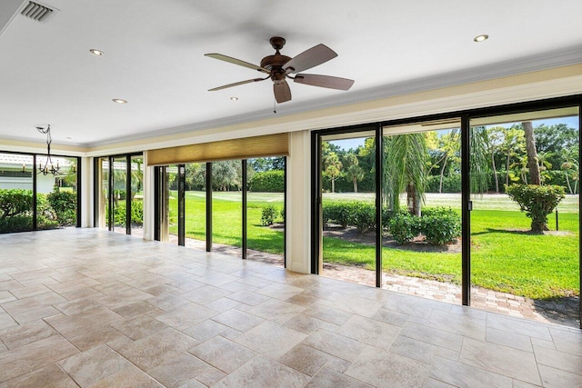 unfurnished room featuring ceiling fan, ornamental molding, and a wealth of natural light