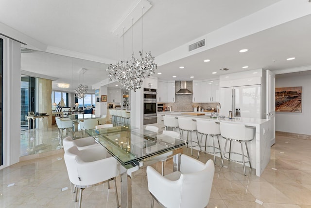 dining space featuring crown molding and a notable chandelier