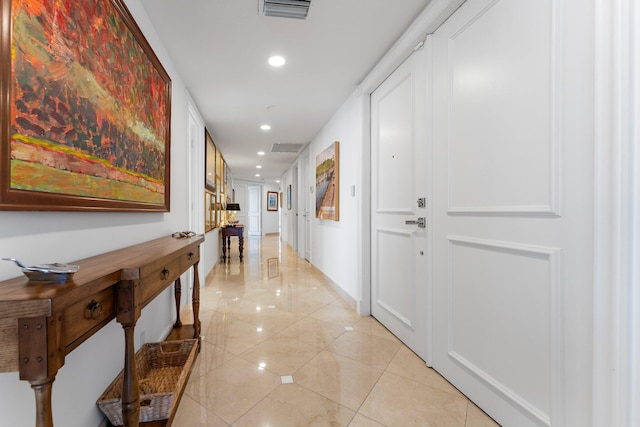 hall featuring light tile patterned floors