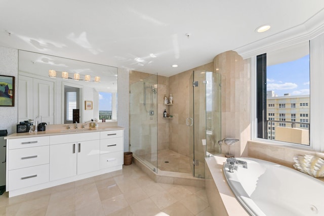 bathroom featuring a healthy amount of sunlight, tile patterned flooring, vanity, and shower with separate bathtub