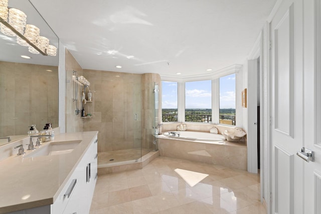 bathroom with tile patterned flooring, vanity, and shower with separate bathtub