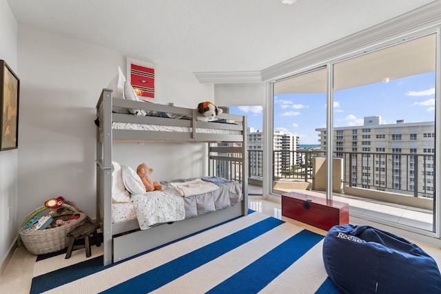 bedroom featuring access to exterior and a wall of windows