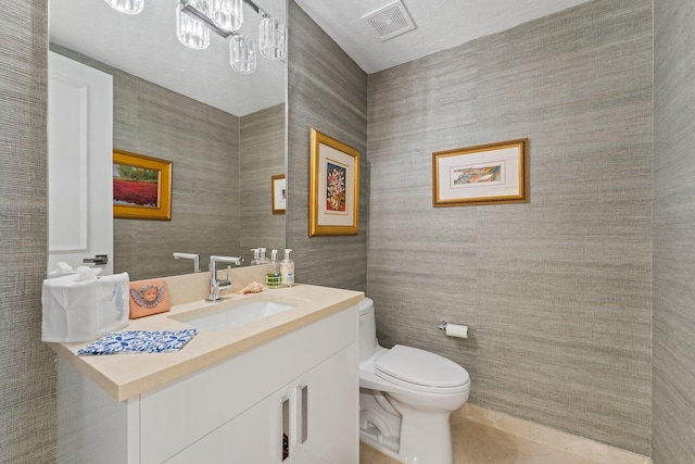 bathroom featuring toilet, tile patterned flooring, and vanity