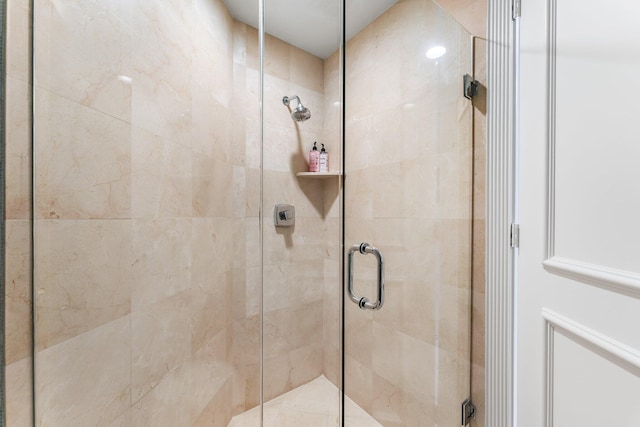 bathroom with a shower with shower door