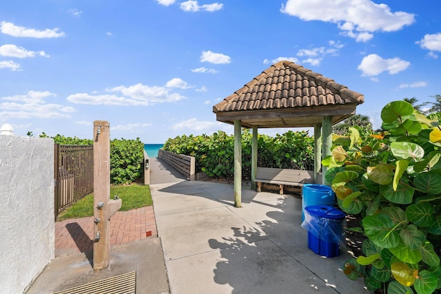 view of patio with a gazebo and a water view