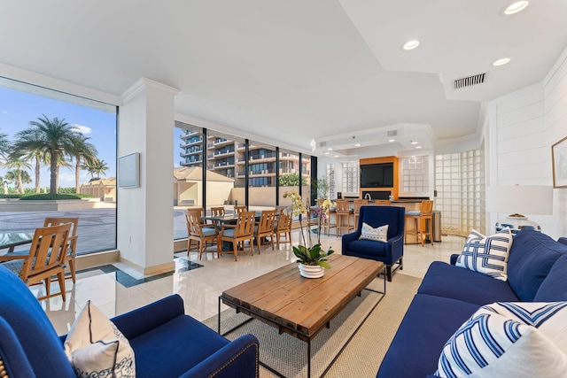 living room featuring light tile patterned floors and expansive windows