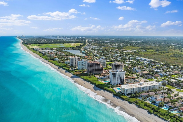 aerial view with a water view and a view of the beach