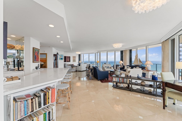 tiled living room with a water view and floor to ceiling windows