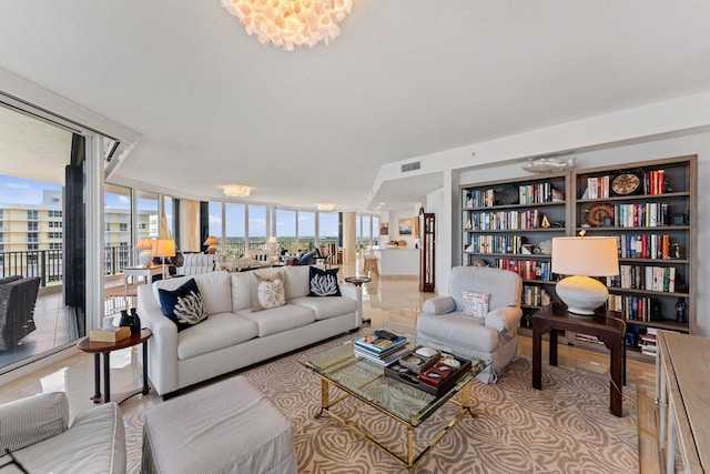 living room featuring floor to ceiling windows and a notable chandelier