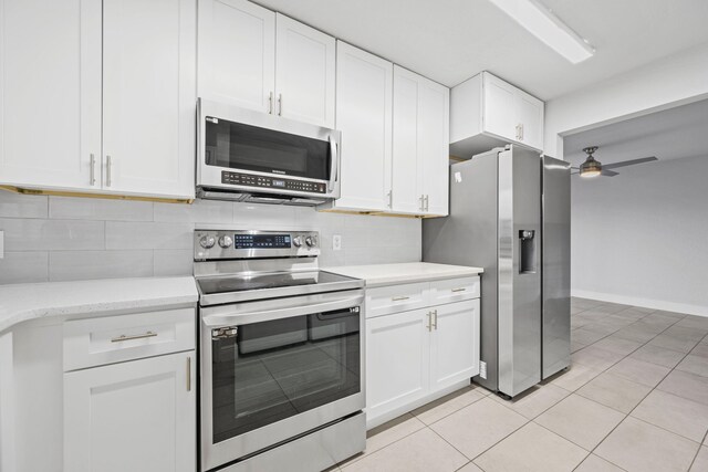 kitchen with white cabinets, tasteful backsplash, stainless steel appliances, and ceiling fan