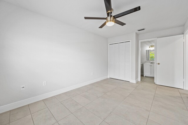 unfurnished bedroom featuring light tile patterned floors, ceiling fan, and a closet